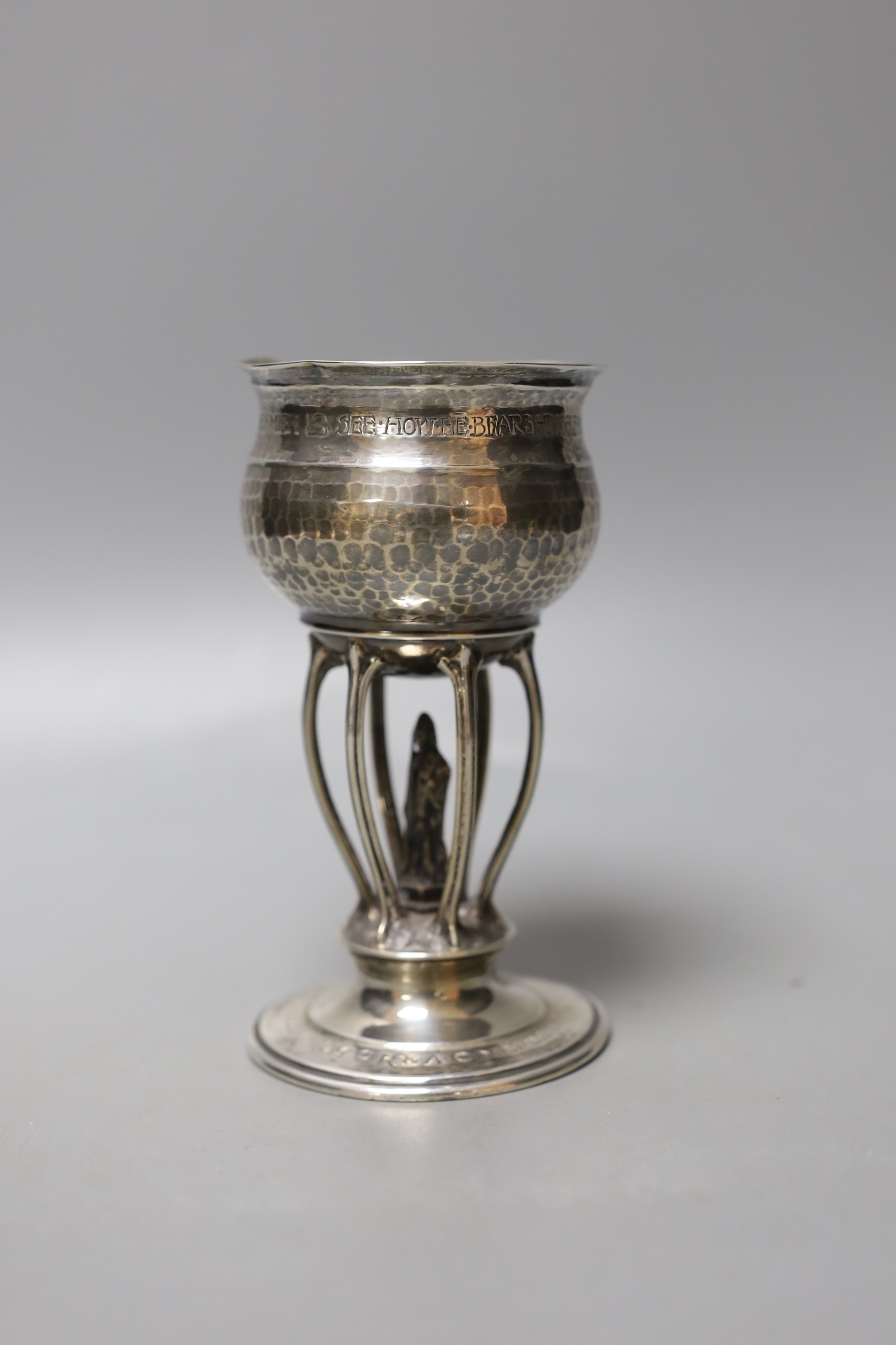 A George V Arts & Crafts planished silver presentation ecclesiastical goblet by Ramsden & Carr, with engraved inscription, London, 1911, 13.5cm, 152 grams.